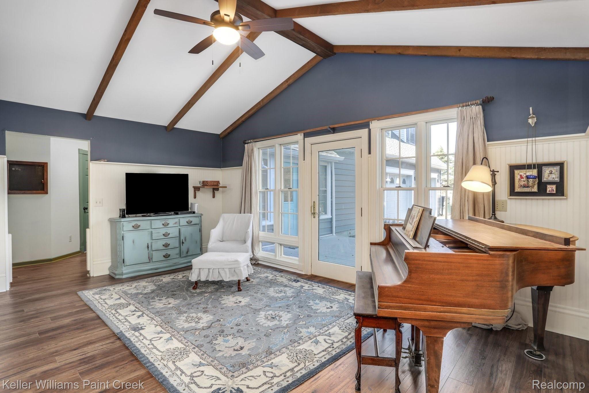 115 Michael Road Lapeer, MI 48446 - Photo 8 of 64 White Bead Board Wainscoting with Slate Blue painted walls create a timeless, classic Farmhouse feel in the main Family Room