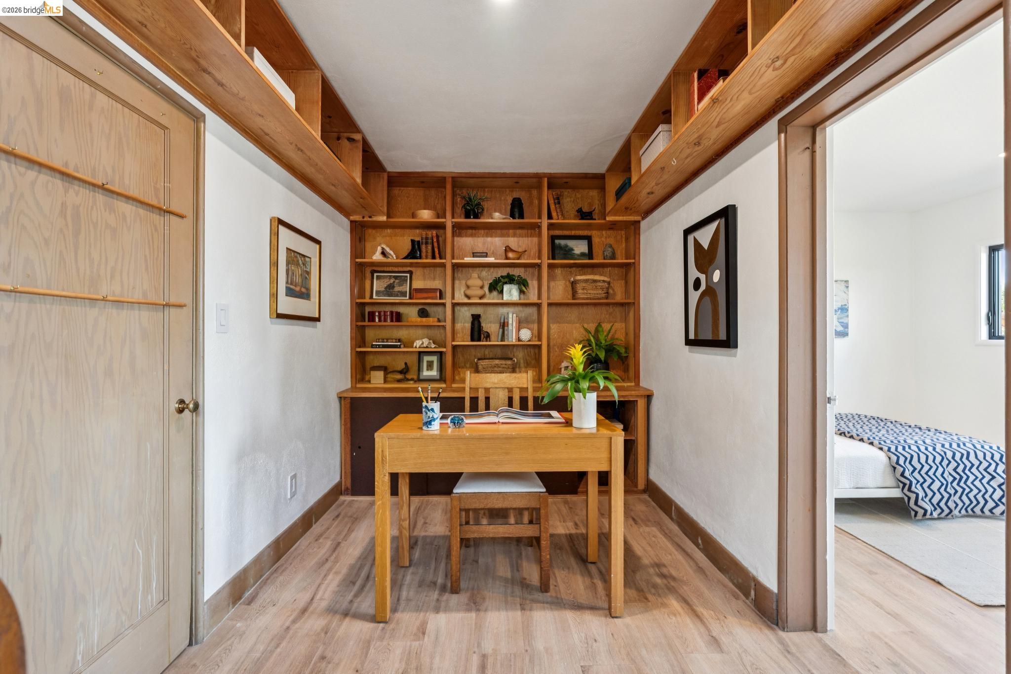38 Highgate Road Kensington, CA 94707 - Photo 47 of 78 Built-in wood shelving, wood-finish flooring, and recessed ceiling lighting