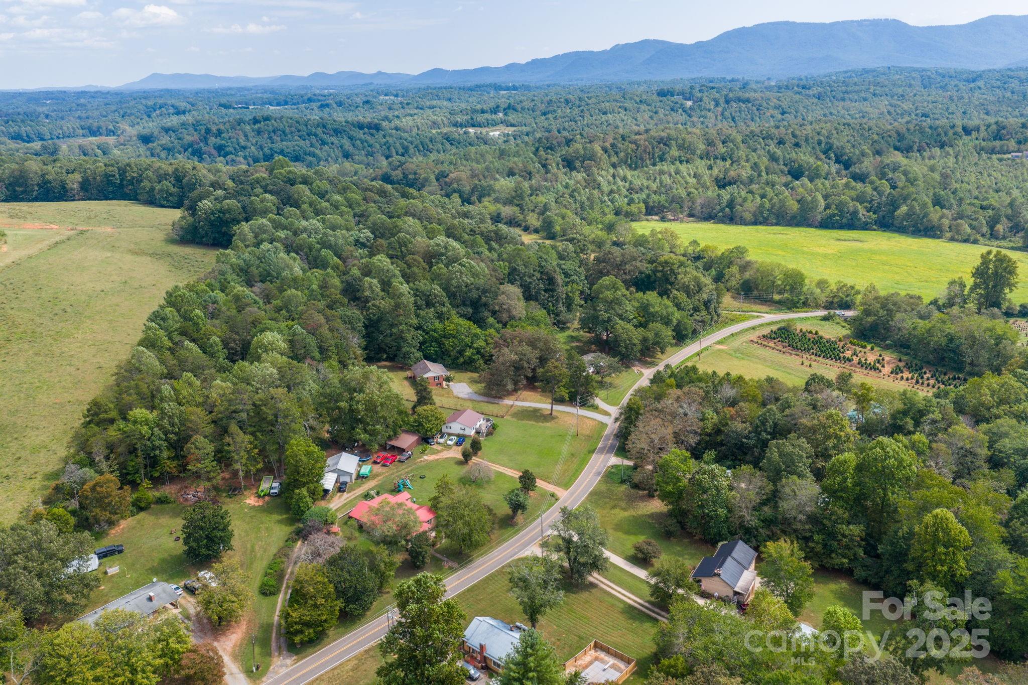 4815 Mt Olive Church Road Morganton, NC 28655 - Photo 12 of 27 a view of a lush green hillside and houses