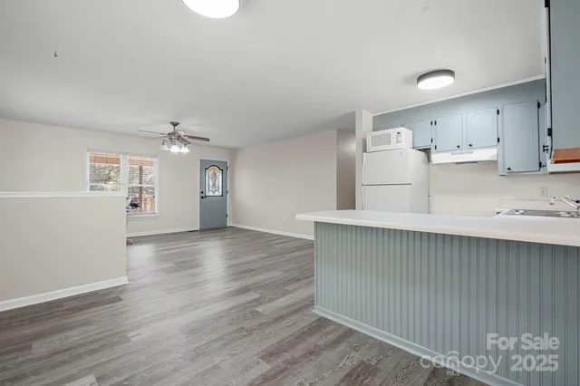 a view of kitchen cabinets and wooden floor
