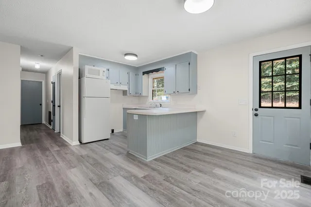 a kitchen with wooden floors and window