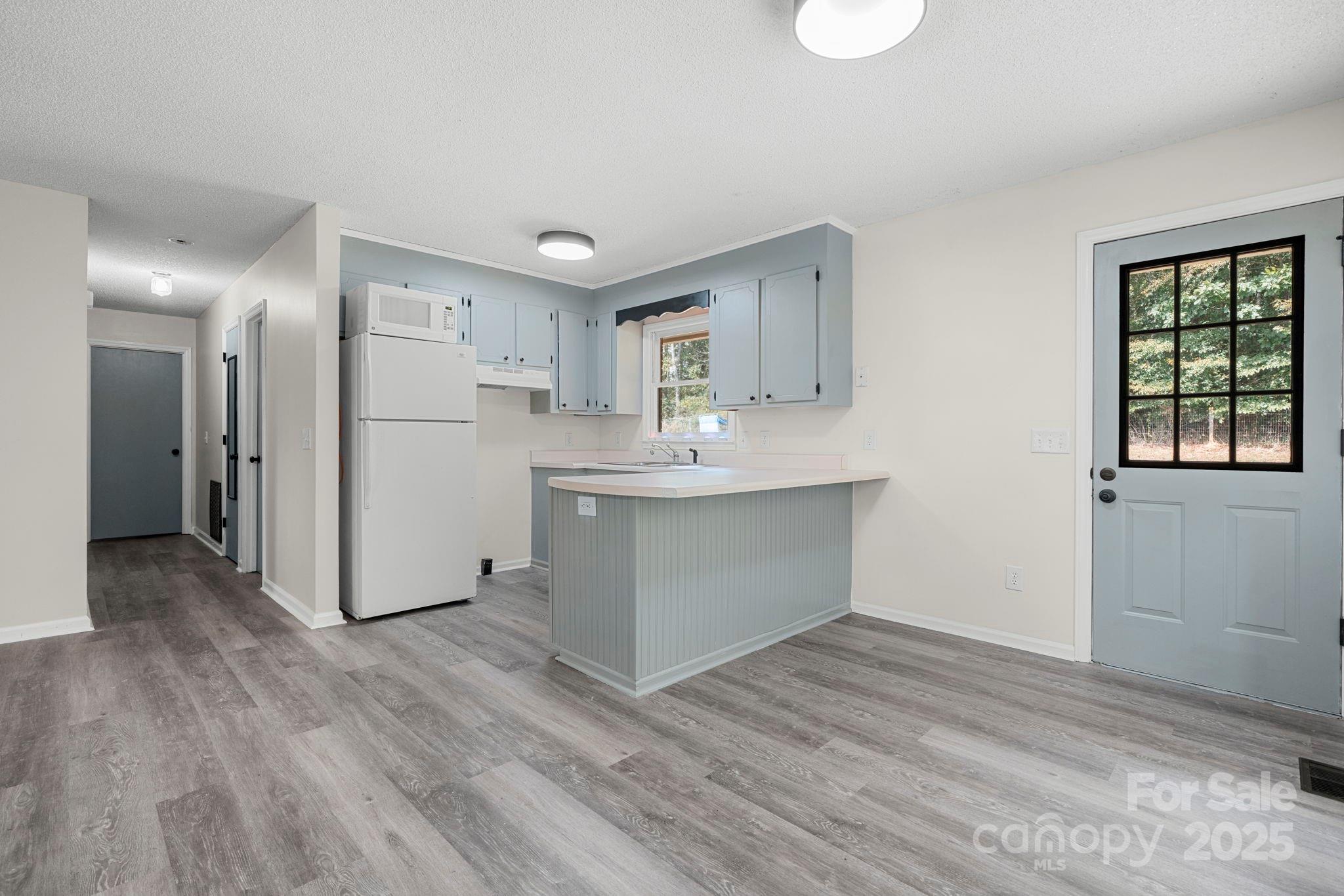 4815 Mt Olive Church Road Morganton, NC 28655 - Photo 17 of 27 a view of kitchen cabinets and wooden floor