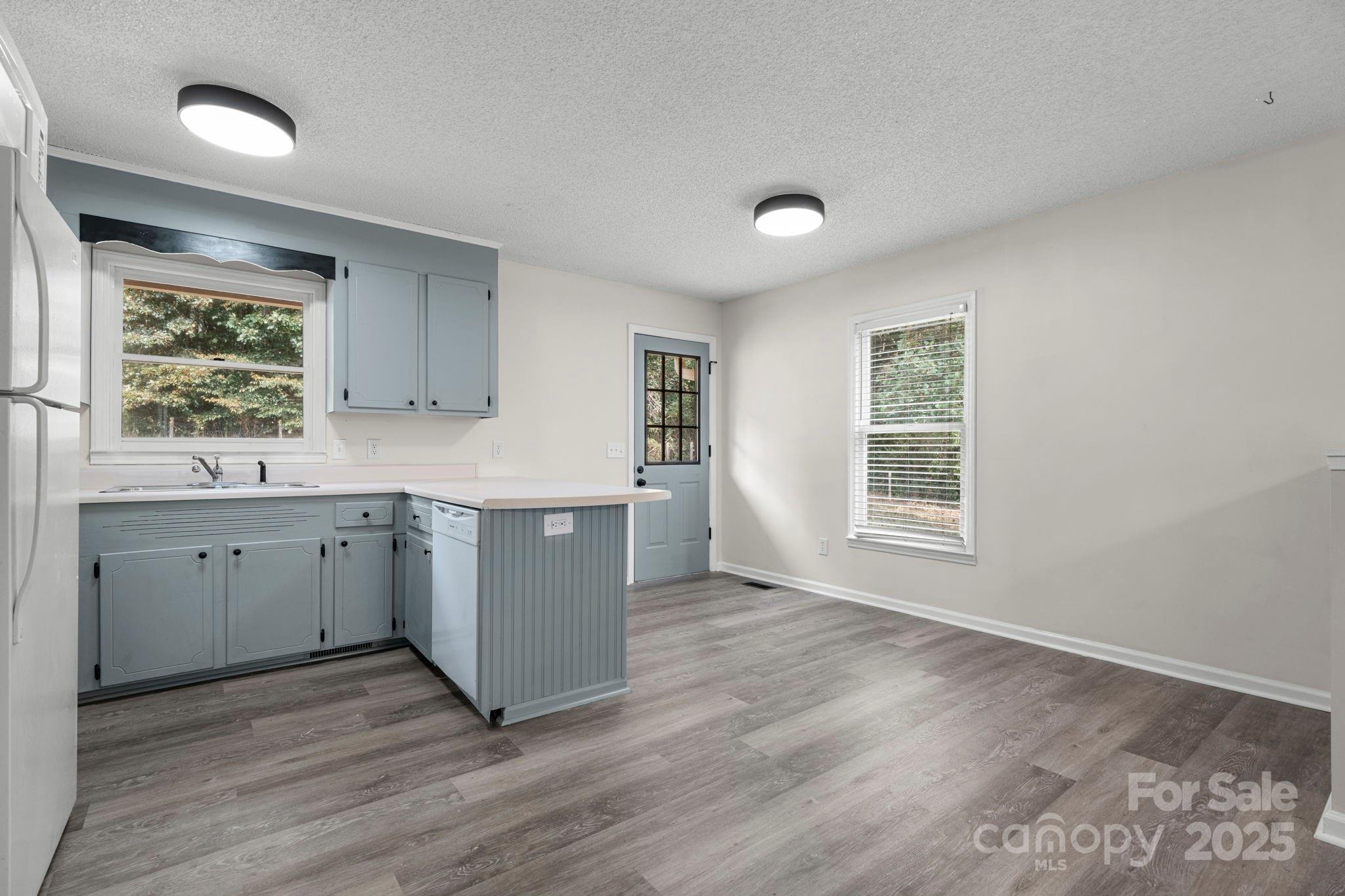 4815 Mt Olive Church Road Morganton, NC 28655 - Photo 18 of 27 a kitchen with wooden floors and window