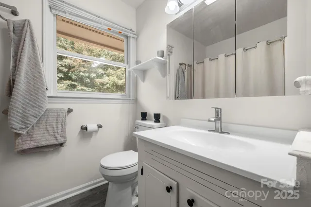 an empty room with a window and ceiling fan