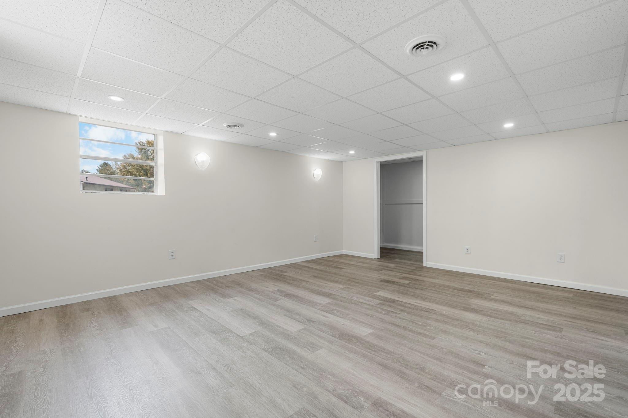 4815 Mt Olive Church Road Morganton, NC 28655 - Photo 23 of 27 an empty room with wooden floor and windows