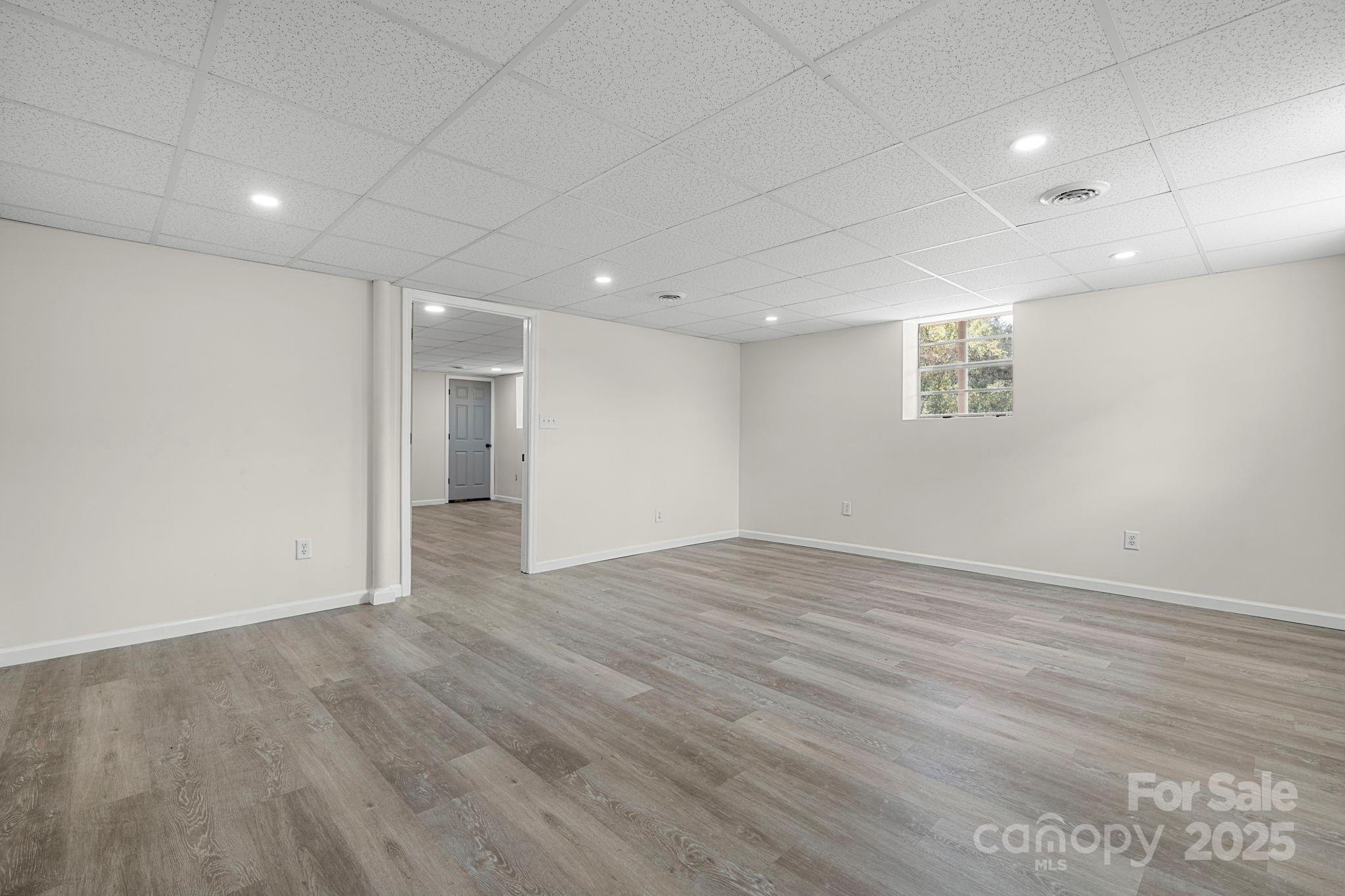 4815 Mt Olive Church Road Morganton, NC 28655 - Photo 24 of 27 an empty room with wooden floor and natural light