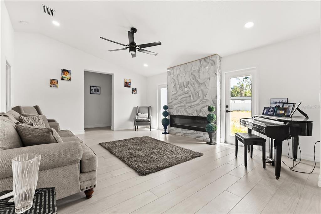 812 Chastain Road Seffner, FL 33584 - Photo 10 of 26 a living room with furniture and a fireplace