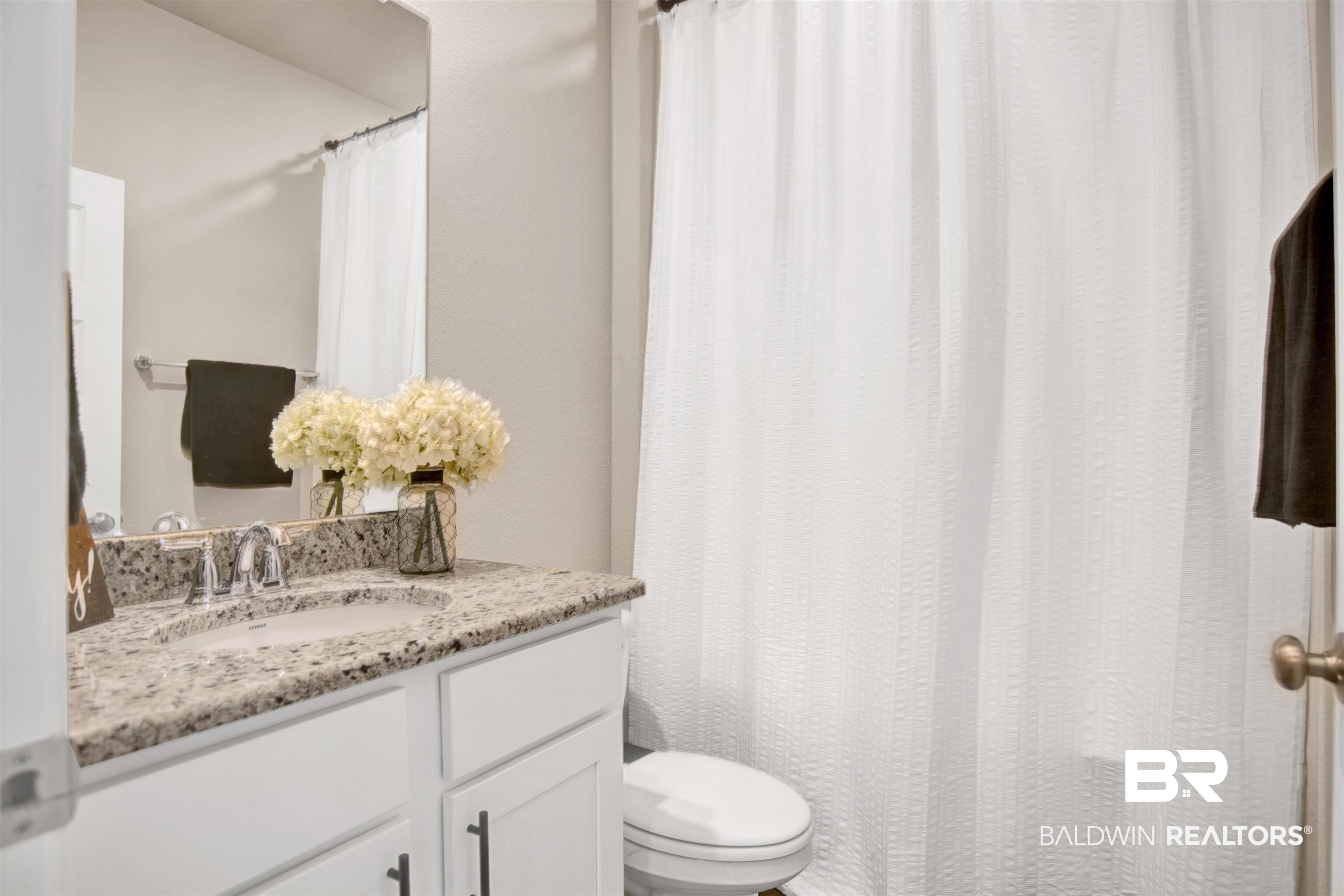 8493 Bronze Lane Foley, AL 36535 - Photo 27 of 38 Bathroom vanity with a granite countertop, undermount sink, and chrome faucet