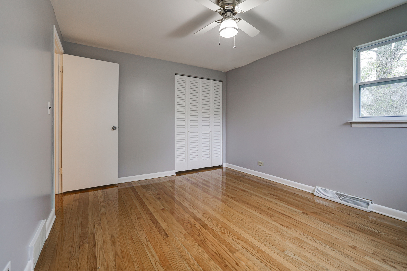 1401 Sunset Ridge Road Northbrook, IL 60062 - Photo 11 of 27 a view of an empty room with wooden floor and a window
