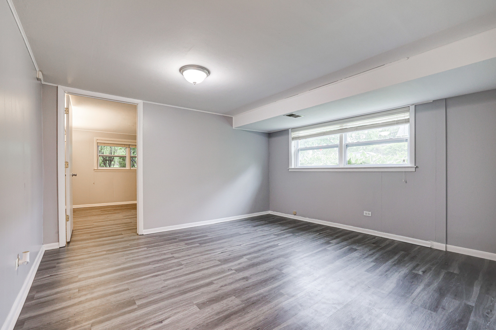 1401 Sunset Ridge Road Northbrook, IL 60062 - Photo 16 of 27 a view of an empty room with wooden floor and a window