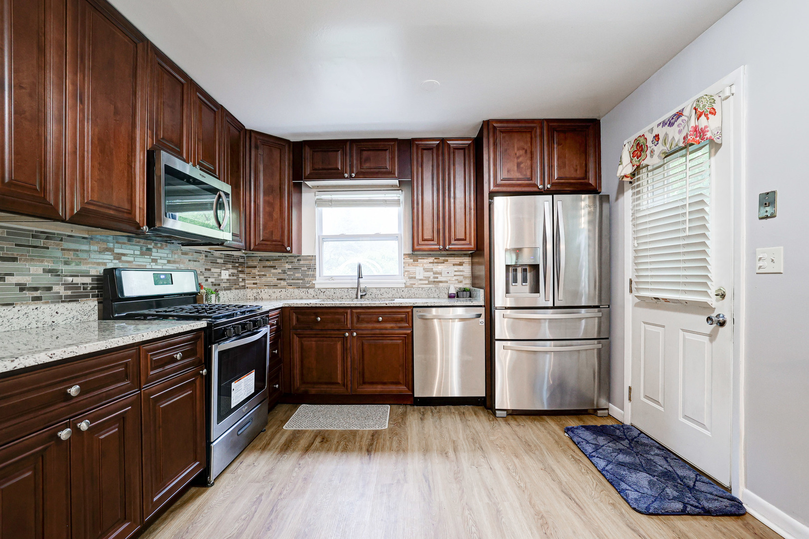 1401 Sunset Ridge Road Northbrook, IL 60062 - Photo 5 of 27 a kitchen with stainless steel appliances granite countertop a refrigerator stove top oven and sink
