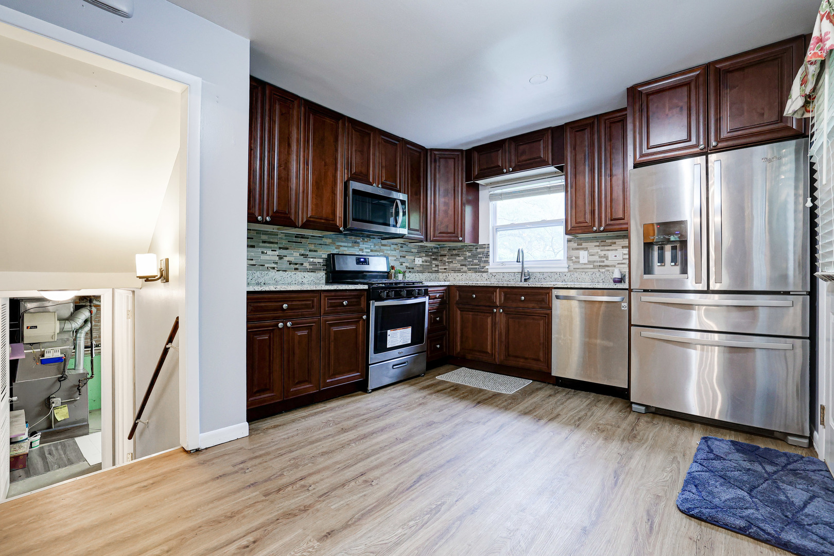 1401 Sunset Ridge Road Northbrook, IL 60062 - Photo 6 of 27 a kitchen with stainless steel appliances granite countertop a refrigerator a stove top oven a sink and dishwasher with wooden floor
