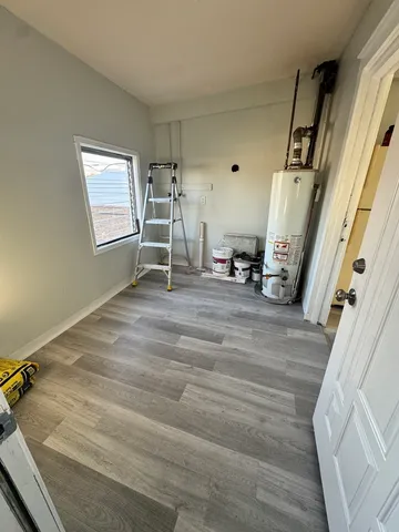 a room with wooden floor and furniture