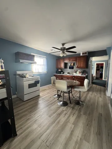 a living room with furniture and a kitchen view