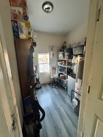 a kitchen with stainless steel appliances granite countertop a stove top oven a sink a dining table and chairs