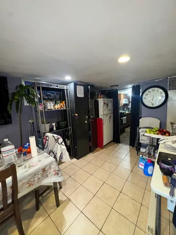 a bedroom with a bed and a flat tv screen on the dresser