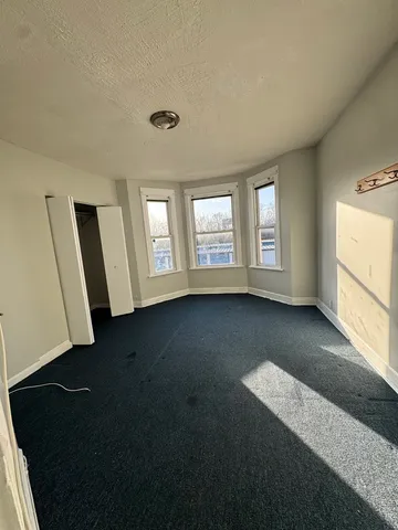 a view of a livingroom with wooden floor and window