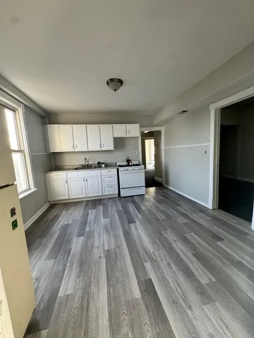 a view of kitchen with sink and refrigerator