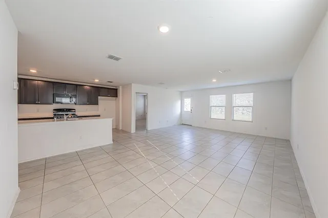 a view of kitchen with windows and refrigerator