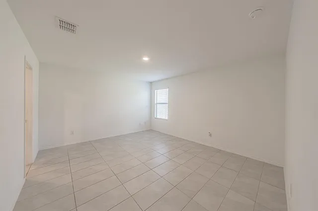 an empty room with white walls and tiles