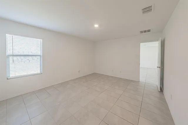 an empty room with a empty space and windows