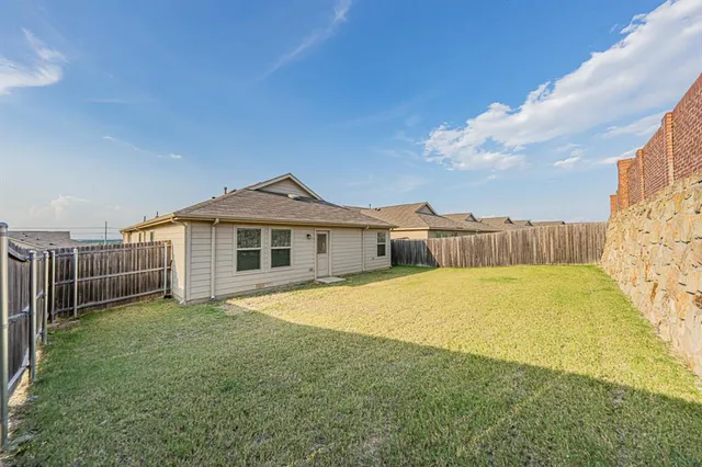 a view of a big building next to a yard