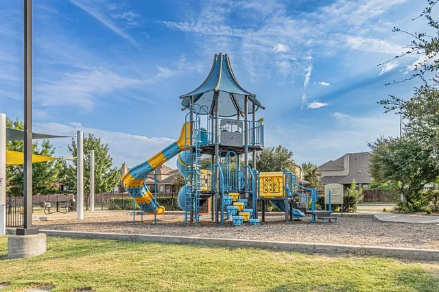 a front view of a house with a garden and a lake view