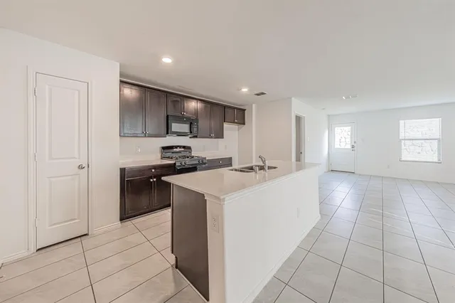 a kitchen with stainless steel appliances a refrigerator sink and cabinets