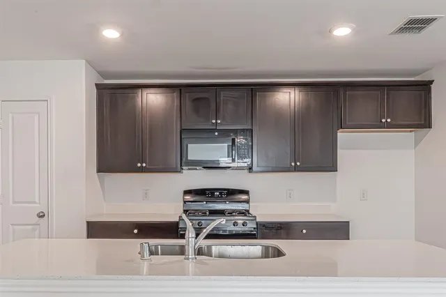 a kitchen with a refrigerator and cabinets