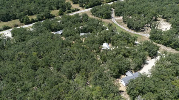 an aerial view of a forest with houses