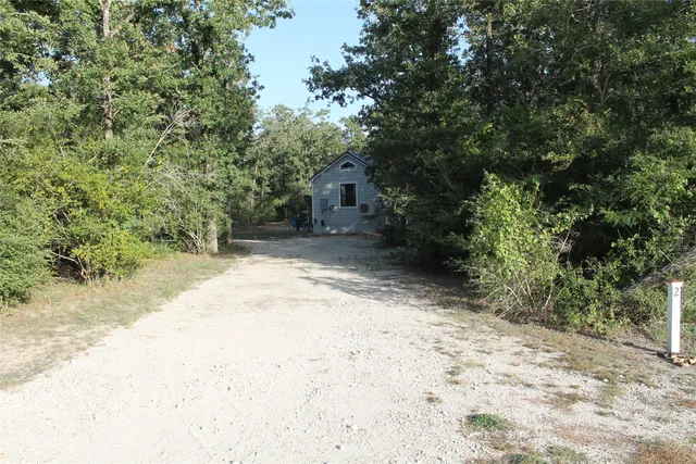 a view of a house with wooden fence