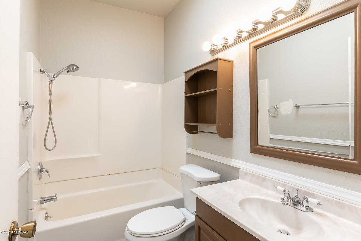 7761 North Rasmussen Avenue Tucson, AZ 85741 - Photo 15 of 23 a bathroom with a sink toilet and shower