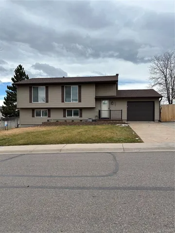 a view of a house with a swimming pool and a yard