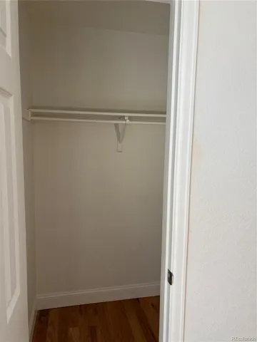 a view of an empty room and wooden floor