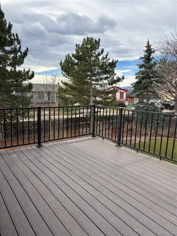 a view of a house with wooden deck