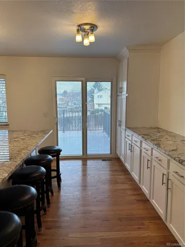 a view of a livingroom with furniture hardwood floor and staircase
