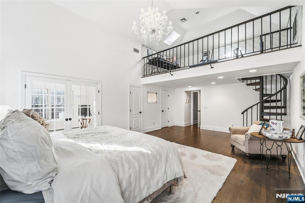 27 Pine Hill Road Old Tappan, NJ 07675 - Photo 28 of 50 a bedroom with a bed and a chandelier