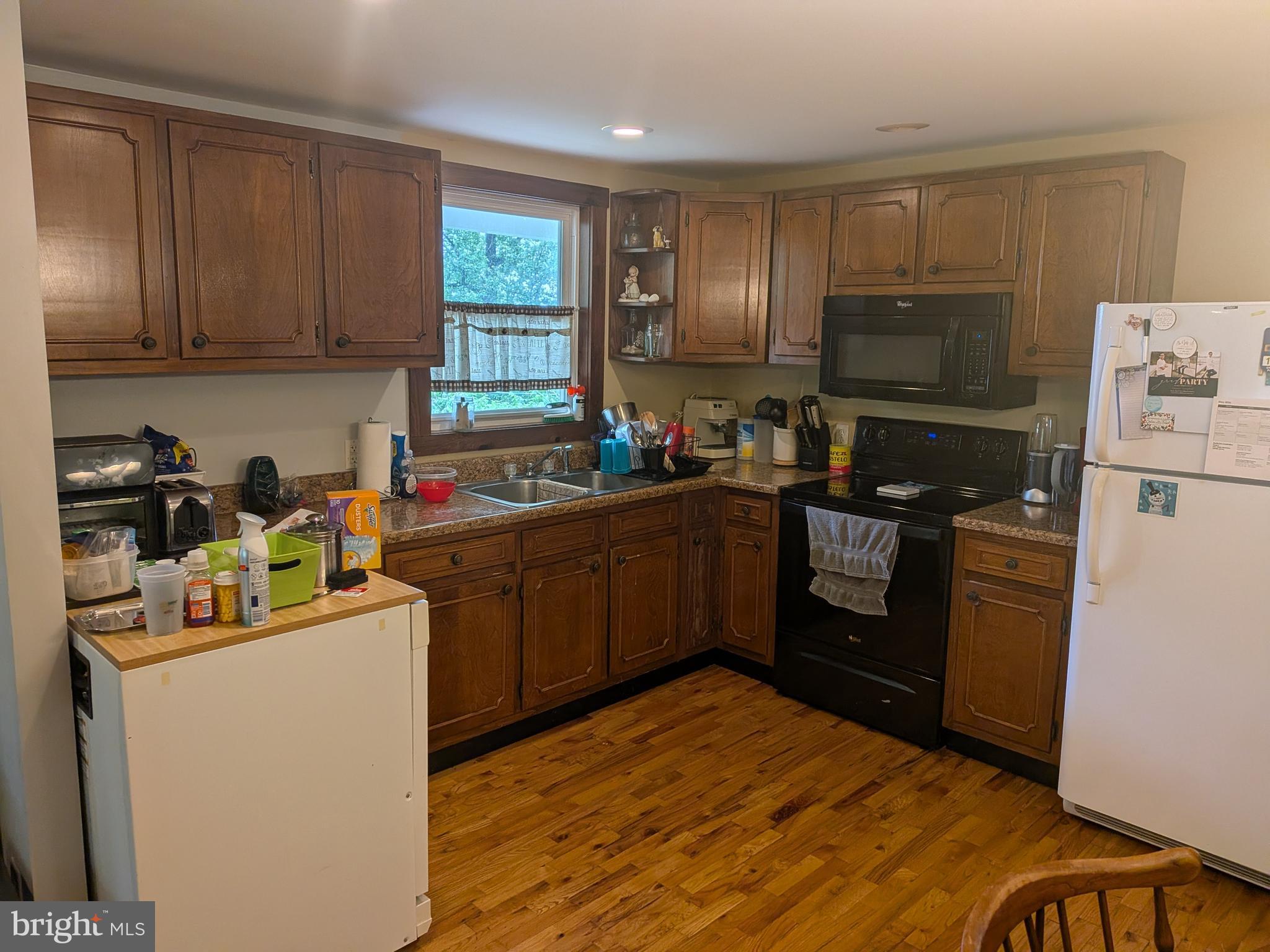 2418 Muddy Run Road Mifflintown, PA 17059 - Photo 18 of 37 a kitchen with a refrigerator sink and wooden cabinets