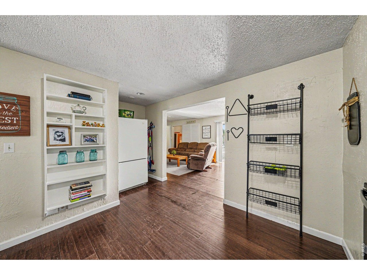 1430 30th Street Road Greeley, CO 80631 - Photo 6 of 22 a living room with furniture and a book shelf