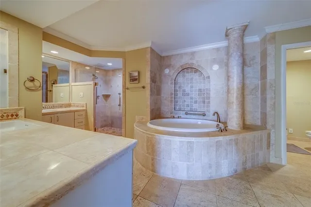 a large spacious bathroom with a tub a sink and mirror