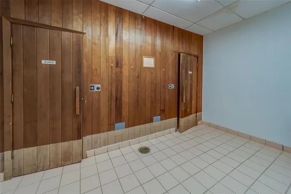 a room with pool table and windows