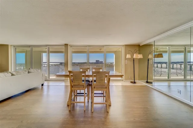 a dining room with furniture and a floor to ceiling window