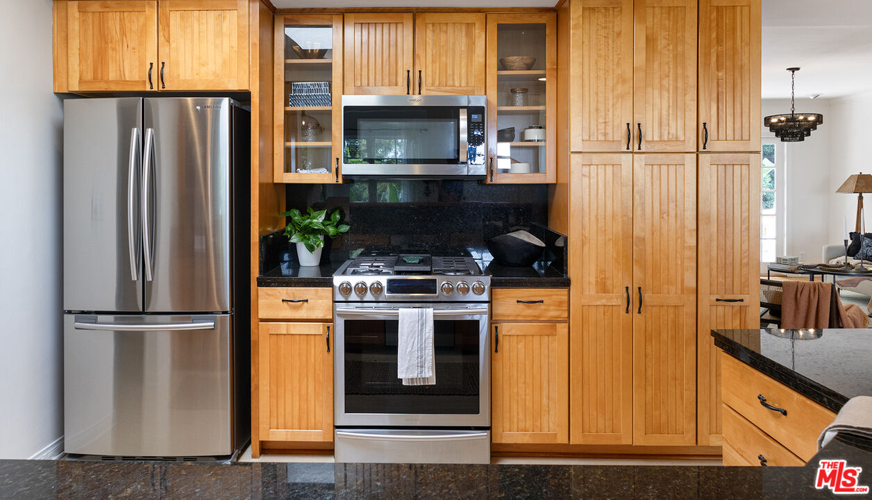 626 Oleander Drive Los Angeles, CA 90042 - Photo 16 of 75 a kitchen with stainless steel appliances granite countertop a refrigerator and a stove top oven