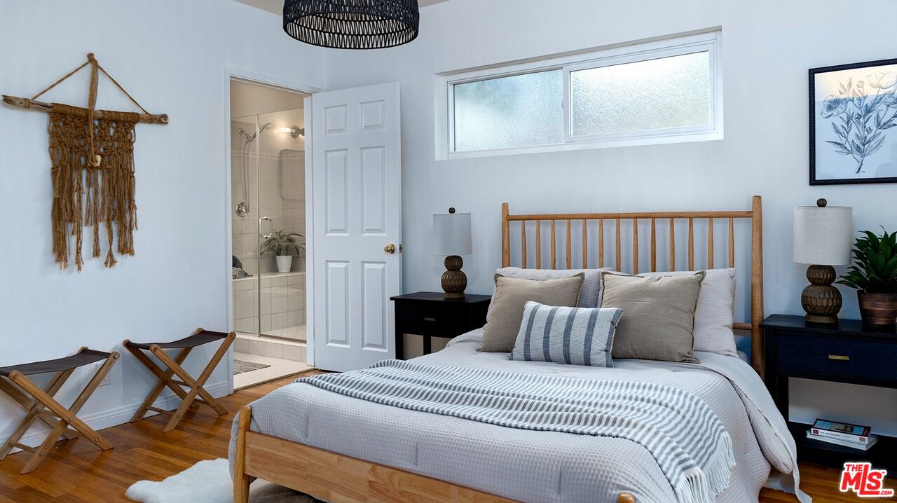 626 Oleander Drive Los Angeles, CA 90042 - Photo 30 of 75 a bedroom with a bed and chair
