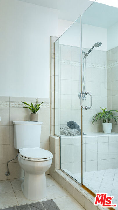 626 Oleander Drive Los Angeles, CA 90042 - Photo 34 of 75 a bathroom with a granite countertop sink a toilet and shower