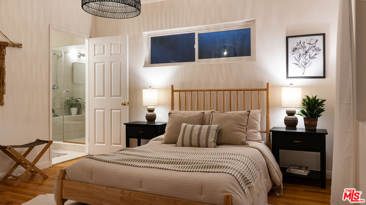 626 Oleander Drive Los Angeles, CA 90042 - Photo 37 of 75 a bedroom with a bed and a painting on the wall