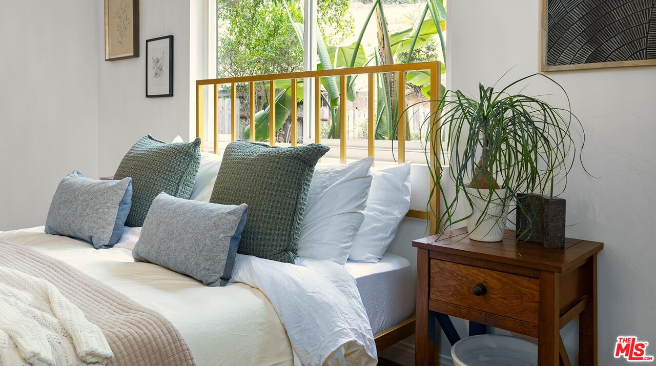 626 Oleander Drive Los Angeles, CA 90042 - Photo 40 of 75 a large bed sitting in a bedroom next to a window