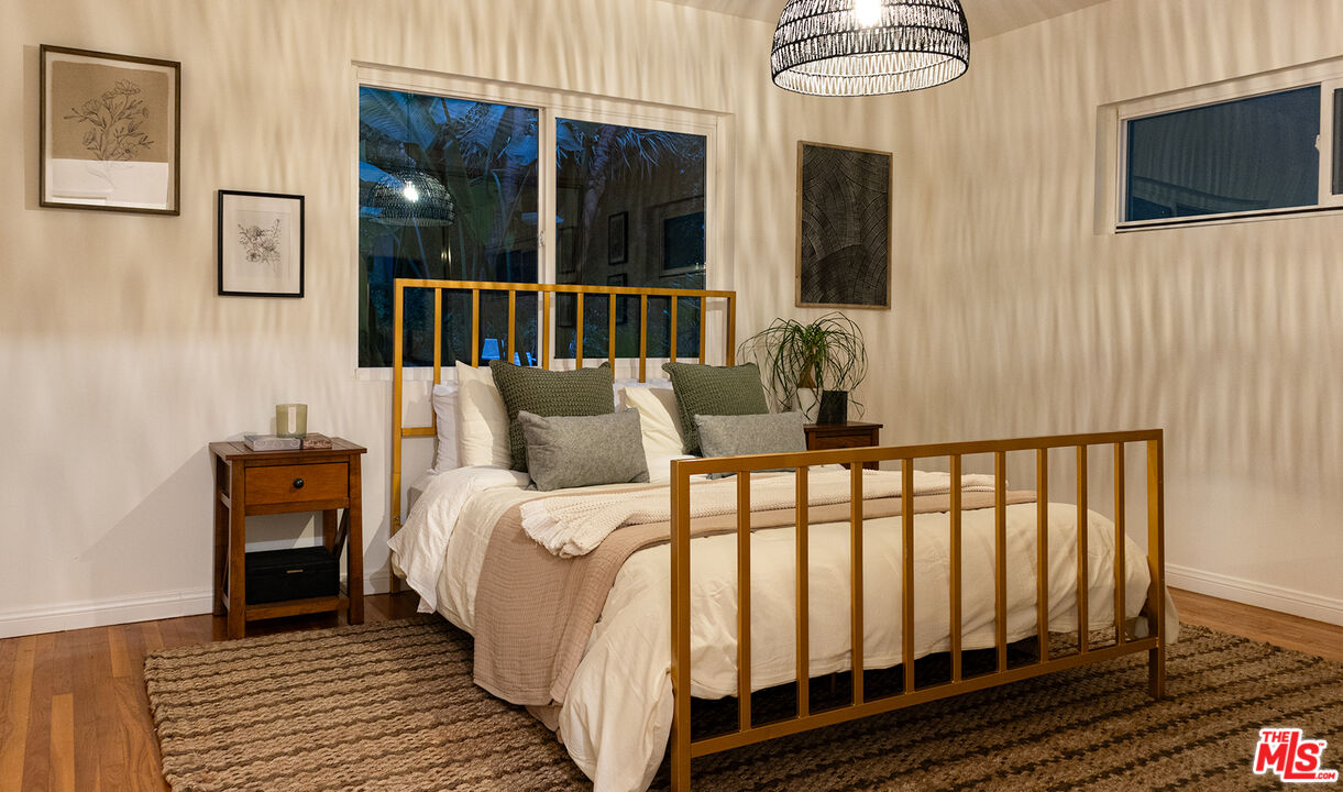 626 Oleander Drive Los Angeles, CA 90042 - Photo 42 of 75 a bedroom with a bed and a flat tv screen on dresser