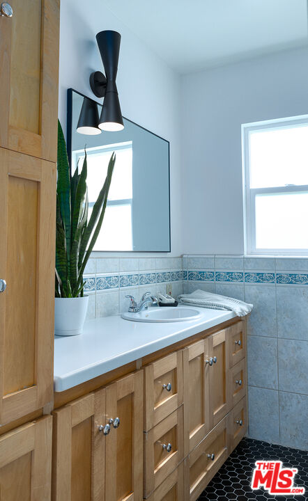 626 Oleander Drive Los Angeles, CA 90042 - Photo 43 of 75 a bathroom with a sink and a mirror