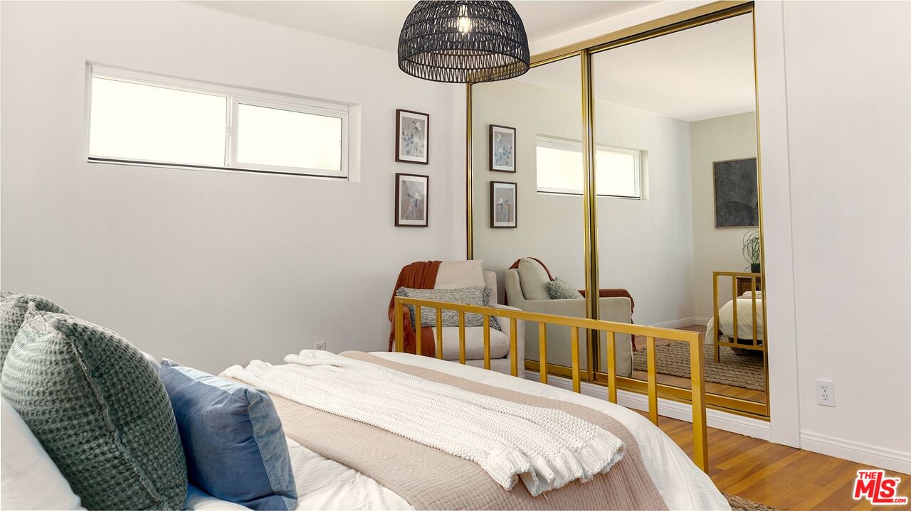 626 Oleander Drive Los Angeles, CA 90042 - Photo 48 of 75 a bedroom with a bed and chandelier